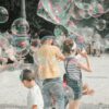 a group of children playing with soap bubbles