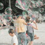 a group of children playing with soap bubbles