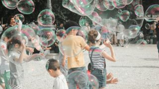 a group of children playing with soap bubbles