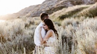 man hugging woman near mountain