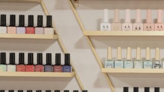 white and black bottles on brown wooden shelf