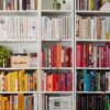 books on white wooden shelf