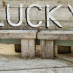a wooden bench with the word lucky written on it