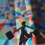 woman holding bag beside mural painting