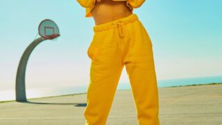 woman in yellow tracksuit standing on basketball court side